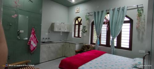 a bedroom with a bed and a sink and a kitchen at Rawat Homestay in Rishīkesh