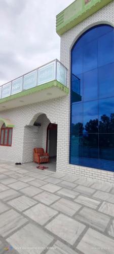 a building with a large window on the side of it at Rawat Homestay in Rishīkesh
