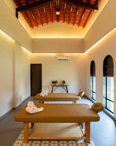 two beds in a room with windows at Mangalam Resort & Spa - Member of Absolute Collection in Aurangabad