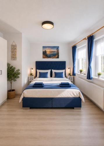 a bedroom with a blue bed and blue curtains at Ferienwohnung Melissa in Unter Feuchten
