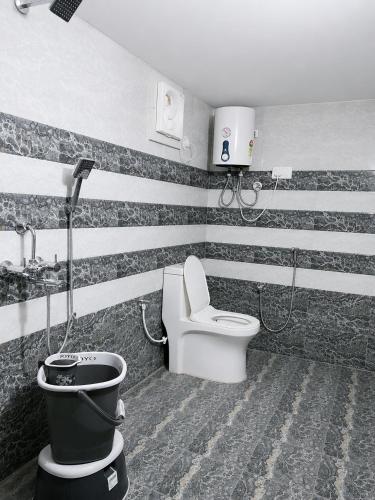 a bathroom with a black and white striped wall at Hotel Robin Jaisalmer Near fort view in Jaisalmer