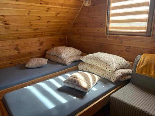 a room with pillows on a bed in a cabin at Orla polana in Gorczyca
