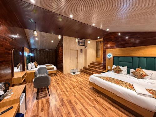 a hotel room with two beds and a desk at The Cedar Pahalgam in Pahalgām