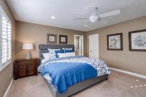 a bedroom with a bed and a ceiling fan at Beautiful Backyard Oasis 5 bedroom 3 Bathroom Home in Placentia