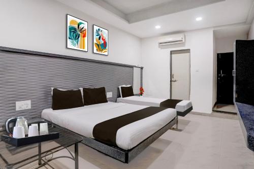 a bedroom with two beds in a room at Hotel O Kolhapur Gate Formerly Tanwani Lodging in Unchagao