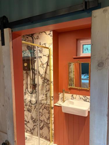 a bathroom with a sink and a mirror at Park Cottage cabin in Bix