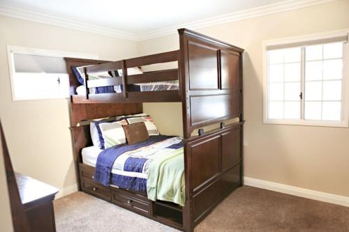 a bedroom with two bunk beds and a bed at Wonderful 4 Bedroom 3 Bath Pool Home 3/4 Mile To Disney in Anaheim