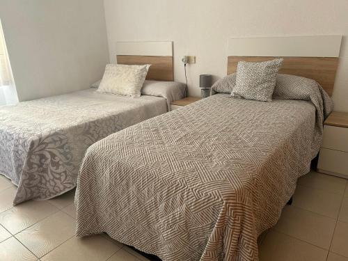 two beds in a hotel room with at Stunning apartment in Oropesa del Mar in Oropesa del Mar