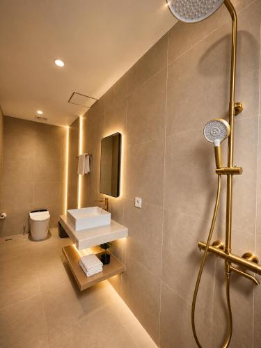 a bathroom with a shower and a toilet at Hotel K Seminyak in Badung