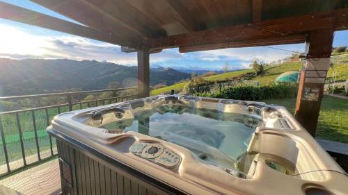 a jacuzzi tub on a balcony with a view at OVIEDO REAL Spa in Oviedo