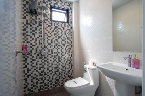 a bathroom with a toilet and a sink and a shower at Pool Villa Maephim 4, by Somjai in Klaeng