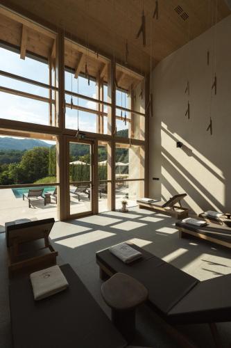 a room with a large window and a table and chairs at Zen Emerald Resort & Spa, Soča river in Most na Soči