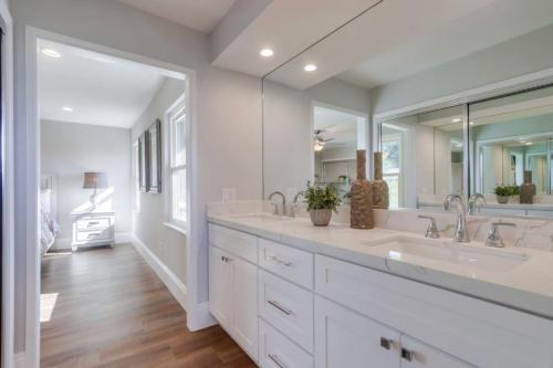 a white bathroom with two sinks and a large mirror at Gorgeous Upgraded 5 Bedroom & 3 Bath Home with pool in Orange