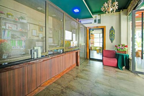 a restaurant with a counter and a red chair at Townhouse Near Tanjung Batu Formerly 900 Inn in Bintulu