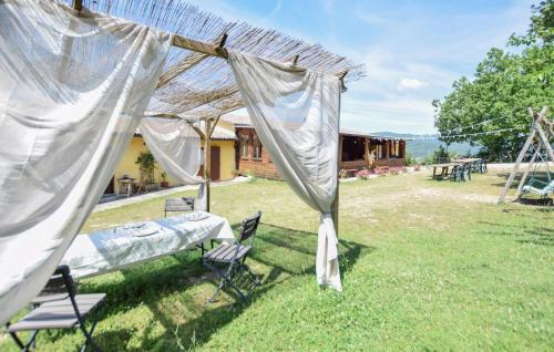 a tent and chairs in a yard with a house at Umbria Montefranco in Montefranco