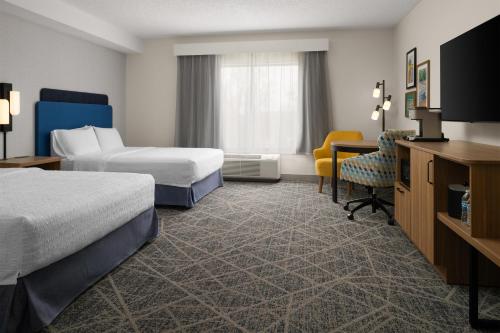 a hotel room with two beds and a desk at Hampton Inn & Suites Chadds Ford in Glen Mills