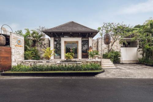 a house with a front porch and a driveway at Aksari Villa Seminyak by Ini Vie Hospitality in Seminyak