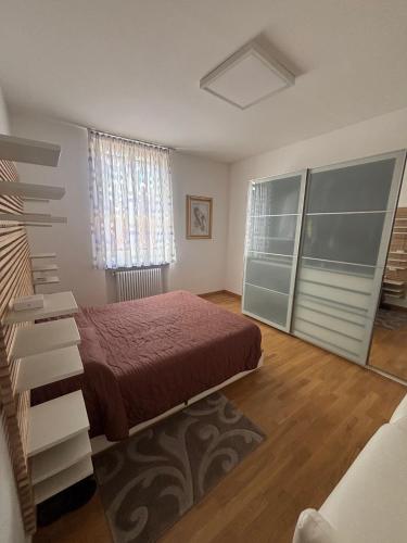 a bedroom with a bed and a large window at Casa Mane in Avezzano