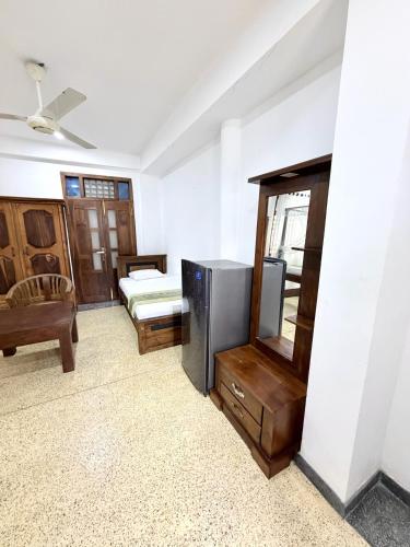 a living room with a television and a bed and a tvictericter at Soulinn Regina Weligama in Weligama