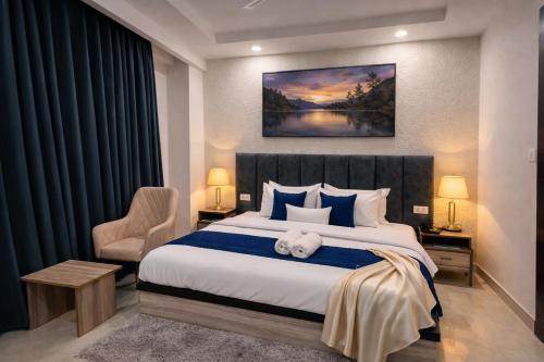 a bedroom with a large bed with a stuffed animal on it at Hotel LA Costa Managed By Sitara Group in Haridwār