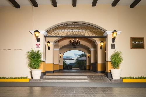 an entrance to a building with two potted plants at Occidental Papagayo - Adults Only All Inclusive in Papagayo, Guanacaste