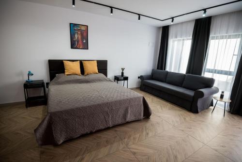 a bedroom with a bed and a couch at Incanto Rentals in Silistra
