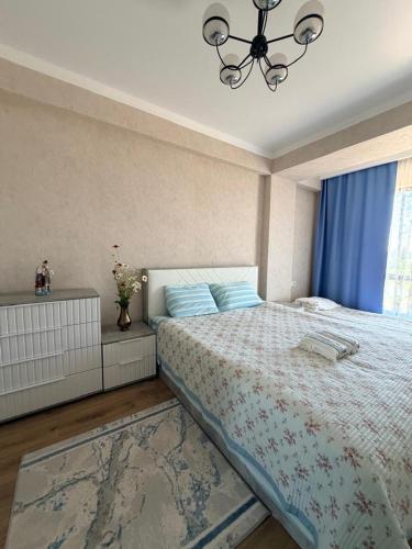 a bedroom with a large bed and a window at vzmorie apart in Bosteri