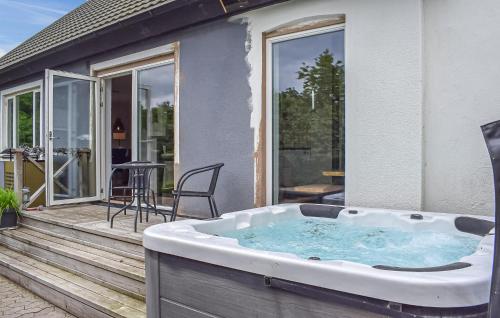 a hot tub on the deck of a house at 4 Bedroom Lovely Home In Simrishamn in Simrishamn