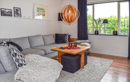 a living room with a couch and a table at 4 Bedroom Lovely Home In Simrishamn in Simrishamn