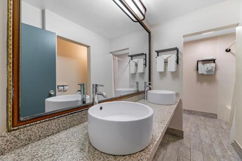a bathroom with two sinks and a large mirror at Quality Inn & Suites Kansas City - Independence I-70 East in Independence