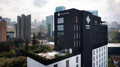 a black building with plants on top of it in a city at Faranda Collection Medellin, a Member of Radisson Individuals in Medellín