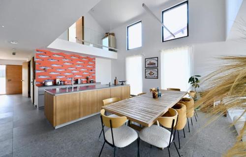 a kitchen with a wooden table and chairs at Architect-Designed Villa with Heated Indoor Pool in Oslip