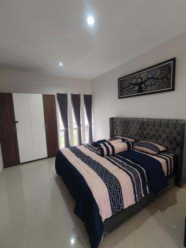 a bedroom with a bed with a blanket on it at Prosperity House Southlinks in Bagam