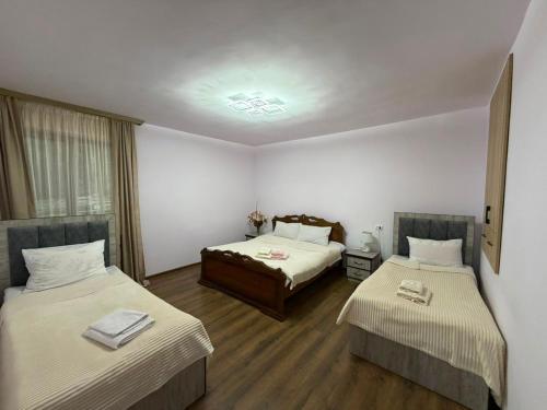 a hotel room with two beds and a window at Narine Bed and Breakfast, Tour in Tatʼev