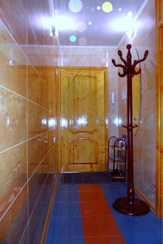 a bathroom with a shower with a tiled floor and a pole at Квартира 89 in Bishkek