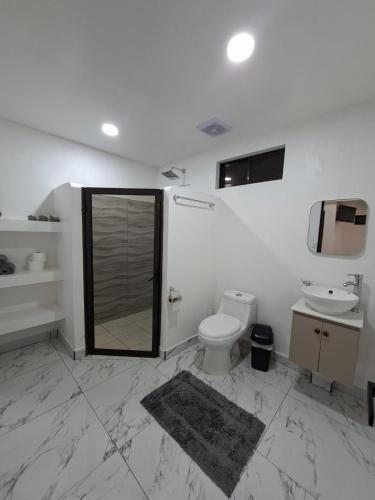 a bathroom with a toilet and a sink at Lions Houses in Parrita