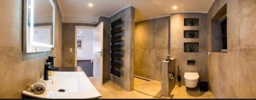 a bathroom with a sink and a toilet in it at Lara Prime in Zepkow