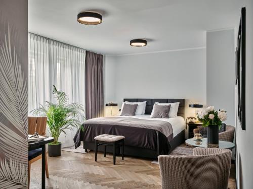 a bedroom with a bed and a table and chairs at Dethloff Art Residence in Warsaw