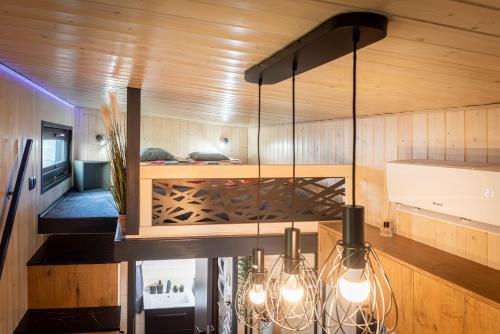 a room with wooden walls and a chandelier at tiny house Eisingen in Eisingen