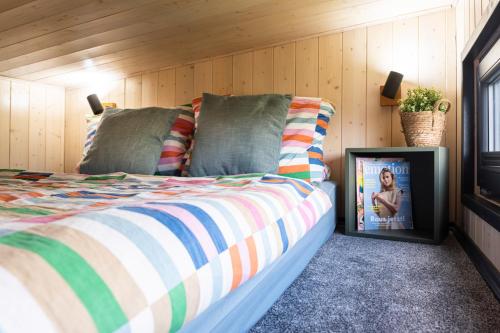 a bedroom with a bed with a tv next to it at tiny house Eisingen in Eisingen