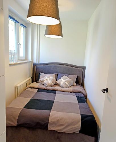 a bed with two pillows on it in a room at Studio Park Śląski m.10 Katowice/Chorzów in Chorzów