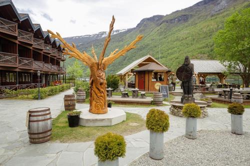 a statue of a tree in front of a building at Flåmsbrygga Hotel in Flåm