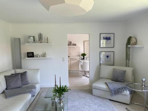 a living room with a couch and a table at Ferienwohnung Edelweiss am Steinberg in Goslar mit Terrasse und Garage in Goslar