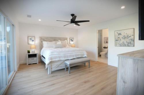 a bedroom with a bed and a ceiling fan at Awesome 5 bedroom 3 bath pool home with in-ground jacuzzi in Orange