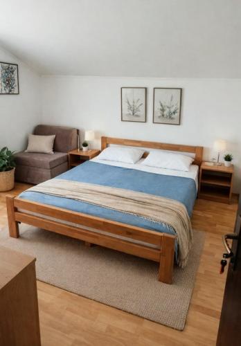 a bedroom with a large bed and a couch at Jakišnica Apartment in Lun