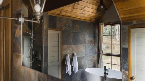 a bathroom with a sink and a shower at Cedar and Stone - Daylesford Region in Glenlyon