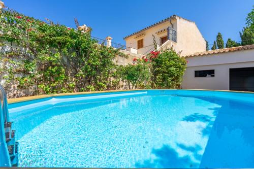 a large blue swimming pool in front of a house at Sant Antoni 39 in Llucmajor