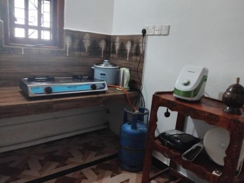 a kitchen with a counter with a toaster and a stove at Nesan’s villa in Trincomalee