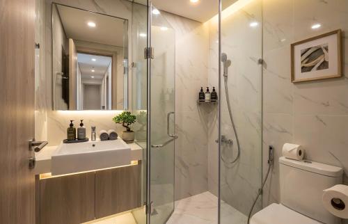 a bathroom with a sink and a shower at Vinhomes D'capitale Hanoi Opus in Hanoi