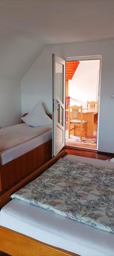a bedroom with a bed and a sliding glass door at Casa Marty in Cârțișoara